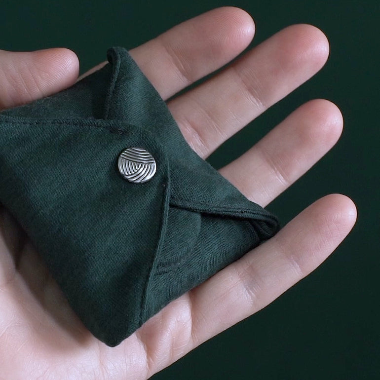 DAME's Reusable Period Pad lifestyle image folded in hand