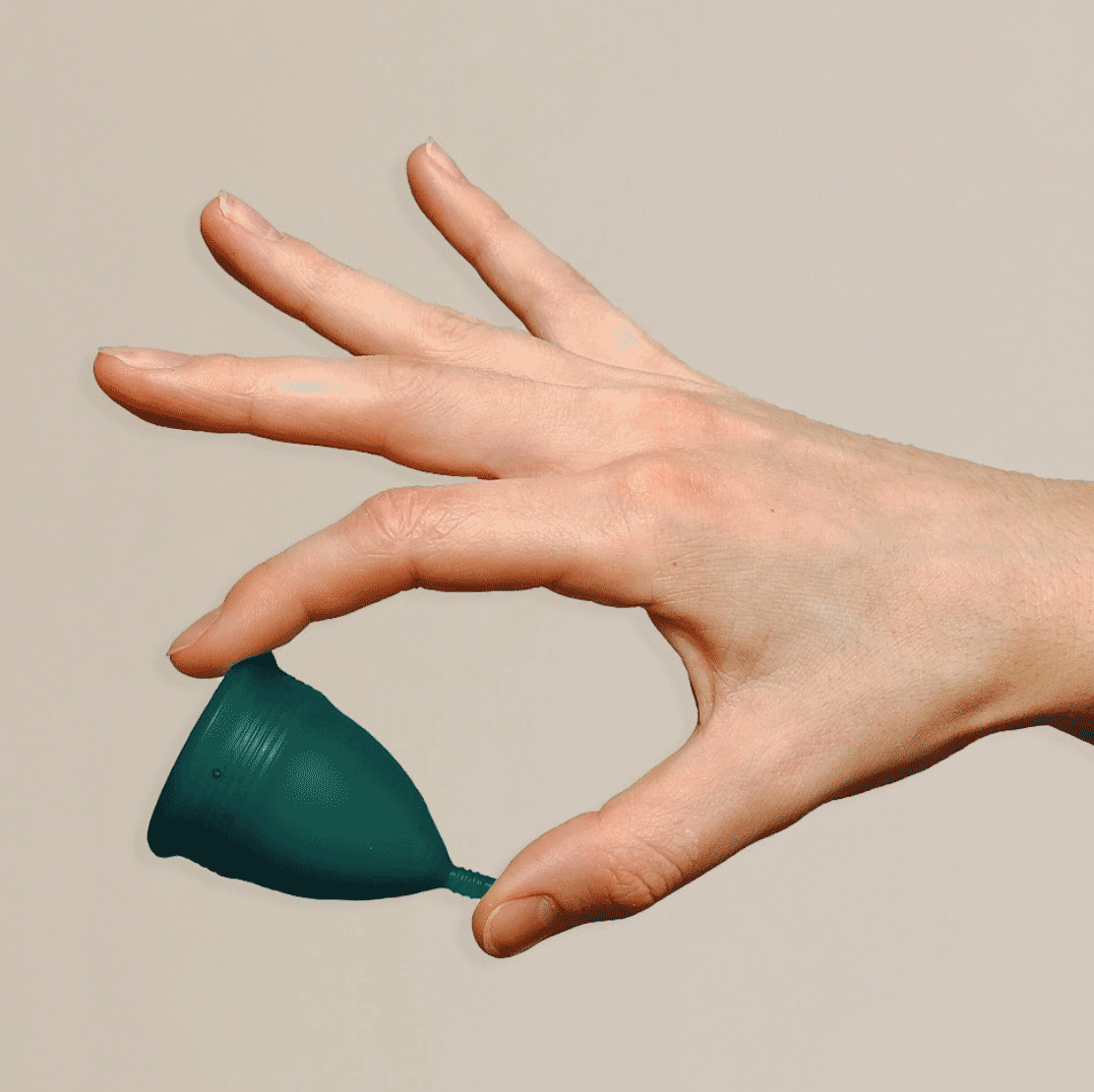 Hand holding DAME period cup
