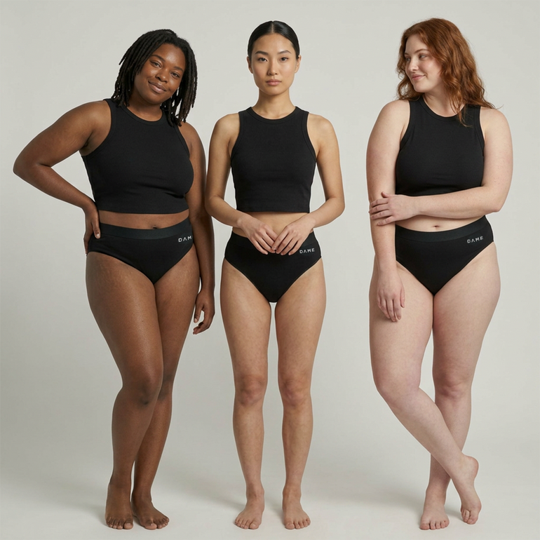 Three women modeling black ribbed tankini tops and matching black bikini-style briefs against a light gray studio background. The brand name 'ELVY' is visible on the waistbands of the briefs.