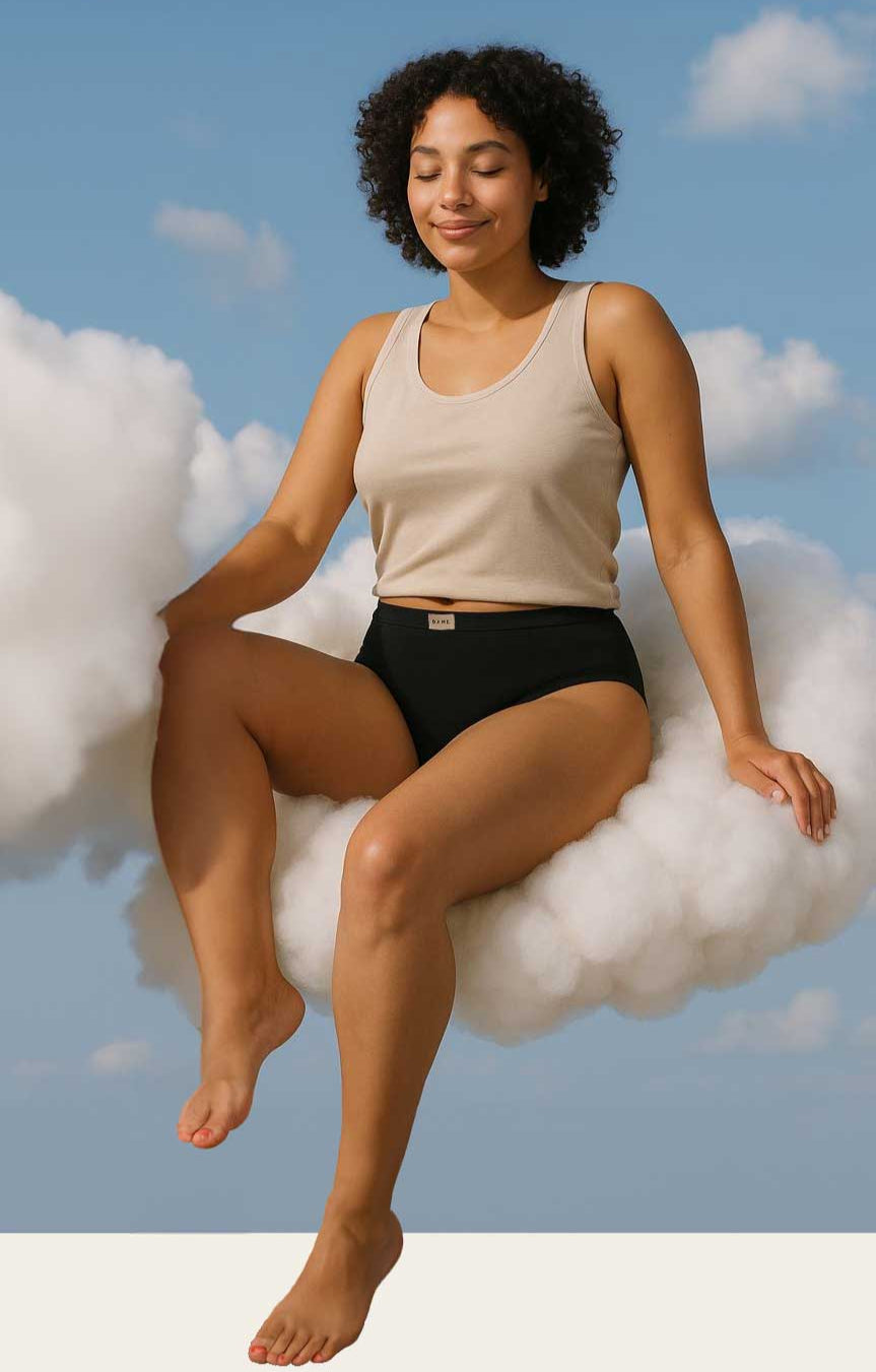 Woman sitting on a cloud with a clear blue sky background